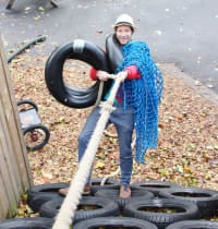 Ivan senior playworker and safety officer climbing tyre wall